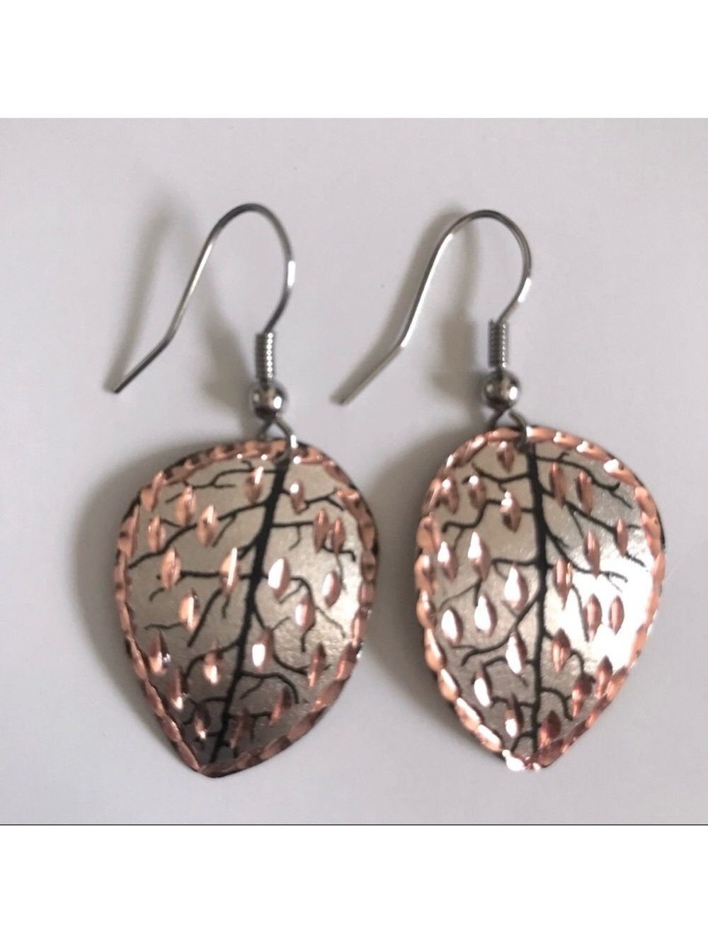Handcrafted earrings. Silver, gold and copper colored leaves.